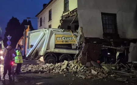 One person died after a garbage truck collided with a building