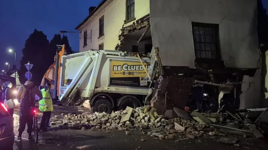 One person died after a garbage truck collided with a building